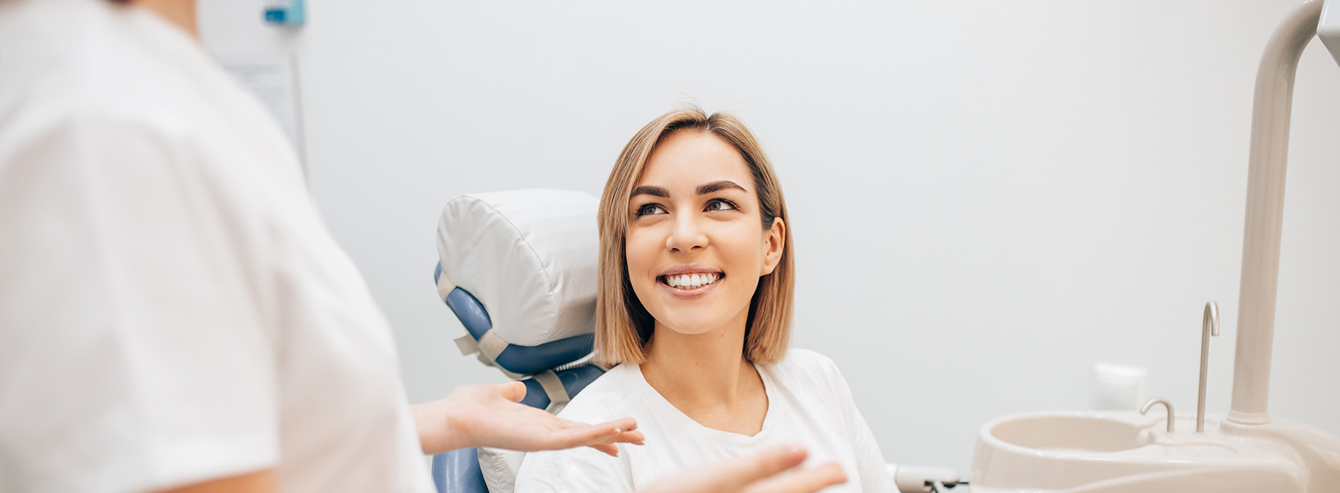 A dental hygienist assisting a patient during a dental examination.