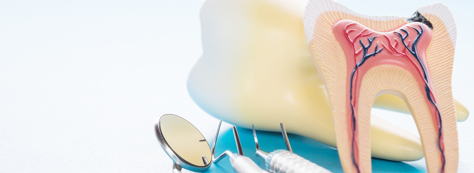 An image featuring a close-up of dental tools, including a toothbrush and dental floss, set against a blue background.