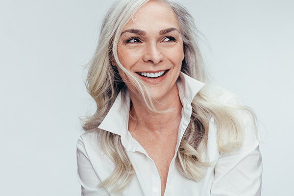 A woman with short hair, smiling at the camera.